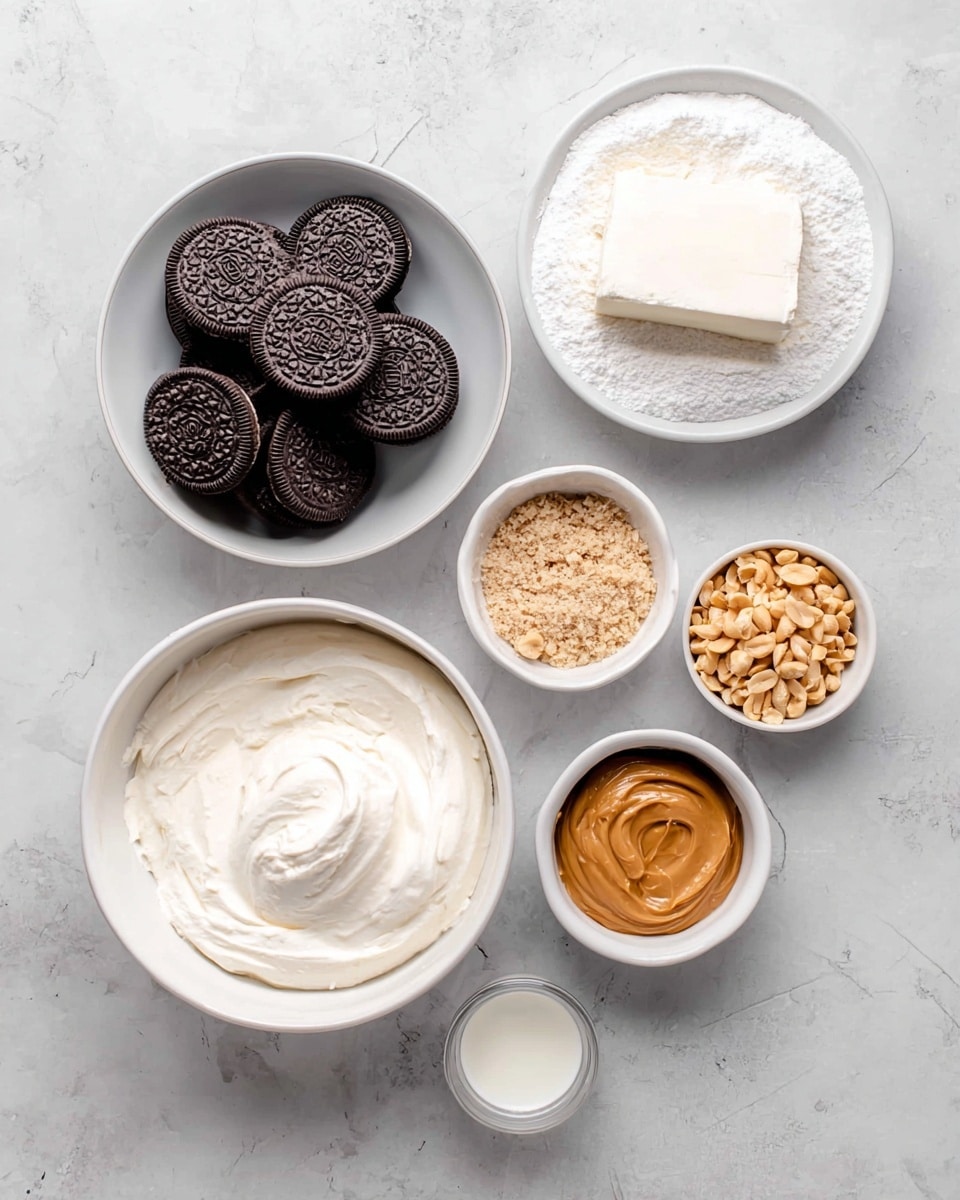 The image shows six white bowls on a white marbled surface. The largest bowl in the top right holds a block of cream cheese on a bed of powdered sugar, both white and smooth. To the left, a medium white bowl is filled with many dark chocolate sandwich cookies stacked together. Below, another large bowl contains thick, creamy white whipped cream with a textured surface. Next to it, a small white bowl contains light brown peanut butter with a smooth and shiny texture. Beside that, a small bowl is filled with chopped peanuts, light tan and crumbly. Finally, a tiny bowl holds a small amount of white liquid, possibly vanilla extract or milk. The overall feel is clean and organized with a top-down view. Photo taken with an iphone --ar 4:5 --v 7