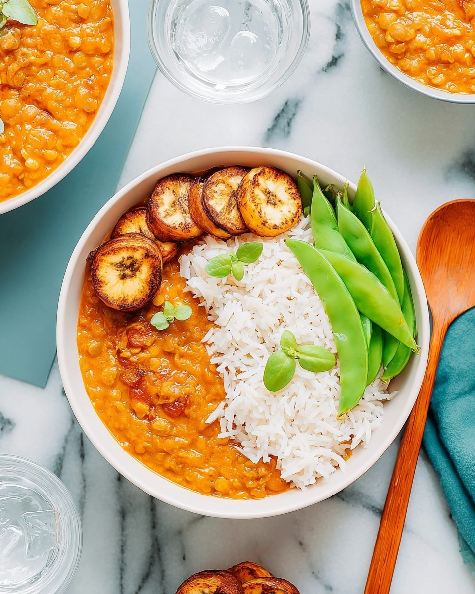 The image shows a white bowl filled with three main layers. The bottom layer is a bright orange lentil stew with a slightly thick texture. On top of the stew, there is a layer of white rice garnished with a few small green leaves. Next to the rice, there are five round slices of golden-brown cooked plantain arranged in a row. On the right side of the bowl, there are several fresh green snow peas placed neatly. A wooden spoon lies inside the bowl on the right edge. The bowl is set on a white marbled surface, and part of two other similar bowls and two glasses of water are visible around it. Photo taken with an iphone --ar 4:5 --v 7